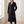 Agathe long double breasted coat in Black worn by a window in a bright room