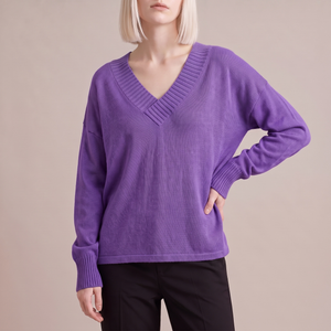 Annabel cashmere V neck sweater in Purple on a light gray studio backdrop