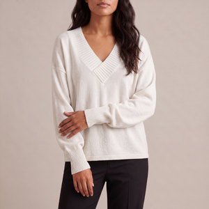 Annabel cashmere V neck sweater in White on a light gray studio backdrop