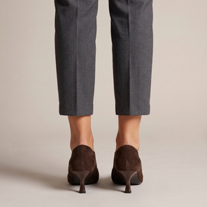 Ariane suede kitten heel pumps in Brown seen from behind on a light gray studio backdrop