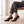 Ariane suede kitten heel pumps in Brown worn seated on a pale oak bench
