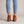 Beatrice suede ankle boots in Cognac seen from behind on a light gray studio backdrop