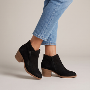 Beatrice suede ankle boots in Black with cropped jeans on a light gray studio backdrop