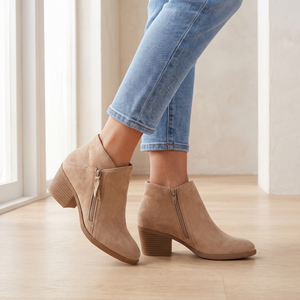 Beatrice suede ankle boots in Beige with cropped jeans on a pale oak floor by a window