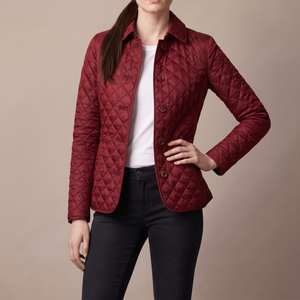 Belinda quilted jacket in Dark Red with one hand on the hip on a light gray studio backdrop