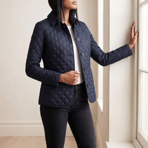 Belinda quilted jacket in Navy Blue worn by a tall window