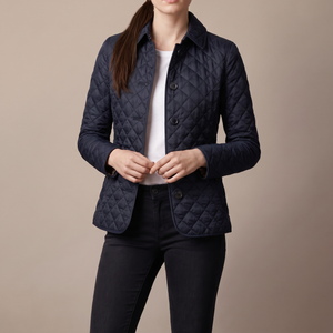 Belinda quilted jacket in Navy Blue on a light gray studio backdrop