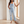 Bianca denim overalls in Light Blue worn full length by a window in a bright room