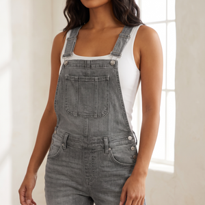 Close view of the Bianca denim overalls bib pocket and buckled shoulder straps in Gray