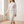 Bonnie ribbed knit set in White, walking across a bright room