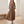 Capucine plaid maxi shirt dress in Brown worn walking with hands in the side pockets