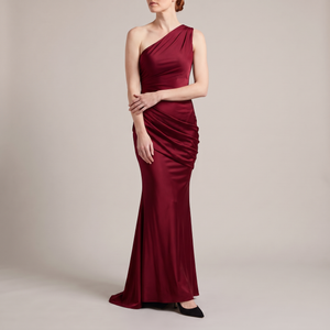 Cecily one shoulder satin maxi dress in Burgundy on a light gray studio backdrop