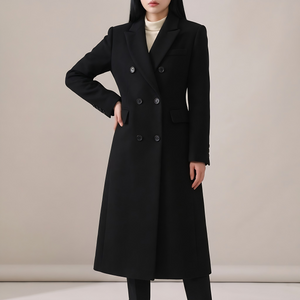 Celeste long wool coat in Black on a light gray studio backdrop
