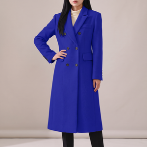 Celeste long wool coat in Blue on a light gray studio backdrop