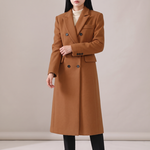 Celeste long wool coat in Brown on a light gray studio backdrop