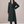 Celeste long wool coat in Dark Green on a light gray studio backdrop