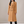 Celeste long wool coat in Camel on a light gray studio backdrop
