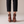 Clarisse block heel pumps in Cognac seen from behind on a light gray studio backdrop