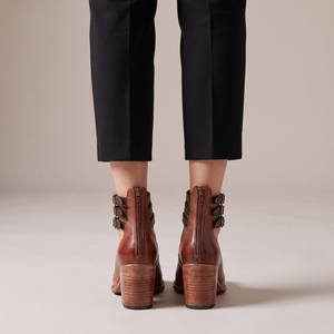 Clarisse block heel pumps in Cognac seen from behind on a light gray studio backdrop