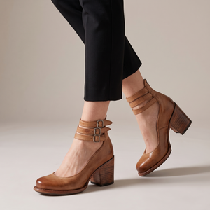 Clarisse block heel pumps in Tan on a light gray studio backdrop