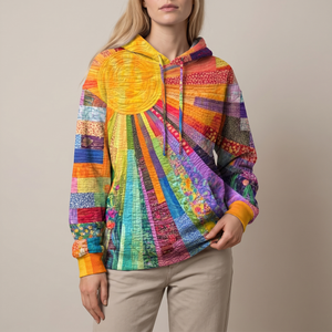 Clemency patchwork sun hoodie on a light gray studio backdrop