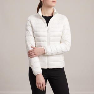 Clementine quilted down jacket in White on a light gray studio backdrop