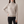 Cressida cashmere turtleneck sweater in Beige on a light gray studio backdrop