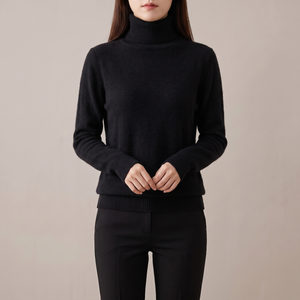 Cressida cashmere turtleneck sweater in Black on a light gray studio backdrop