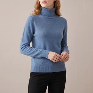 Cressida cashmere turtleneck sweater in Blue on a light gray studio backdrop