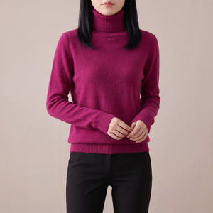 Cressida cashmere turtleneck sweater in Fuchsia on a light gray studio backdrop