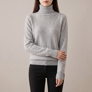 Cressida cashmere turtleneck sweater in Gray on a light gray studio backdrop