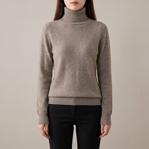 Cressida cashmere turtleneck sweater in Taupe on a light gray studio backdrop