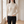 Cressida cashmere turtleneck sweater in Ivory worn by a window in a bright room