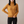 Cressida cashmere turtleneck sweater in Mustard on a light gray studio backdrop