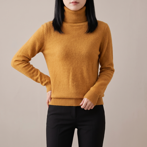 Cressida cashmere turtleneck sweater in Mustard on a light gray studio backdrop