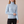 Cressida cashmere turtleneck sweater in Sky Blue on a light gray studio backdrop