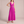 Cristina pleated maxi dress in Fuchsia on a light gray studio backdrop