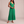 Cristina pleated maxi dress in Green on a light gray studio backdrop