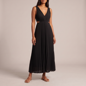 Cristina pleated maxi dress in Black with flat nude sandals on a light gray studio backdrop