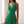 Close front view of the Cristina dress in Green showing the V neckline, gathered pleated bodice and side cutouts