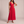 Cristina pleated maxi dress in Red on a light gray studio backdrop