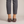 Elinor round toe flats in Dark Brown worn with cropped gray trousers on a light gray studio backdrop