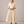 Eloise wrap midi dress in Beige on a light gray studio backdrop