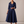 Eloise wrap midi dress in Navy Blue on a light gray studio backdrop