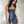 Elsie butterfly sequin mini dress in Navy Blue against a plaster wall