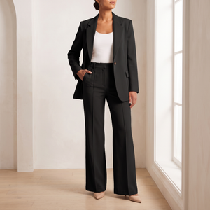 Eudora blazer and wide leg pants set in Black, worn by a window in a bright room