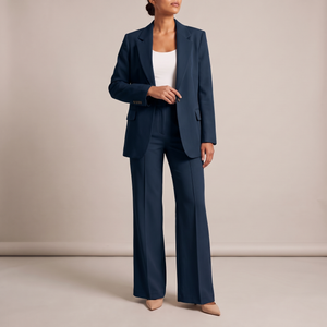 Eudora blazer and wide leg pants set in Navy Blue on a light gray studio backdrop