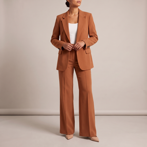 Eudora blazer and wide leg pants set in Rust on a light gray studio backdrop