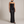 Faustine strapless maxi dress in Black with a sheer scarf at the neck on a light gray studio backdrop
