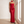 Faustine strapless maxi dress in Red, full length, standing by a window